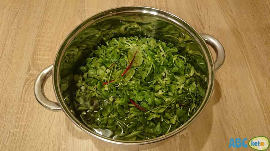 Keto egg salad ingredients, leafy green vegetables, arugula, lamb's lettuce, beet tops
