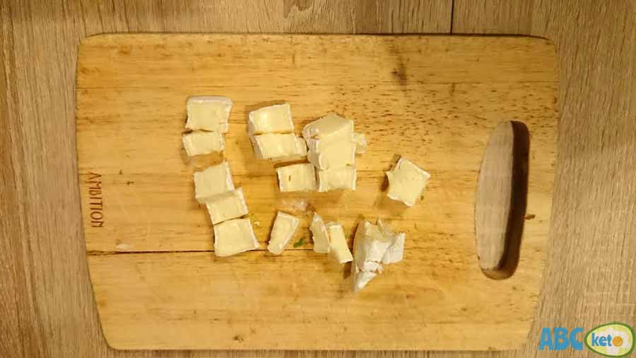 Keto egg salad recipe instructions, cutting Camembert cheese into smaller pieces