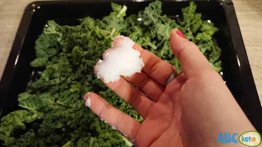 Keto kale chips, greasing kale with coconut oil