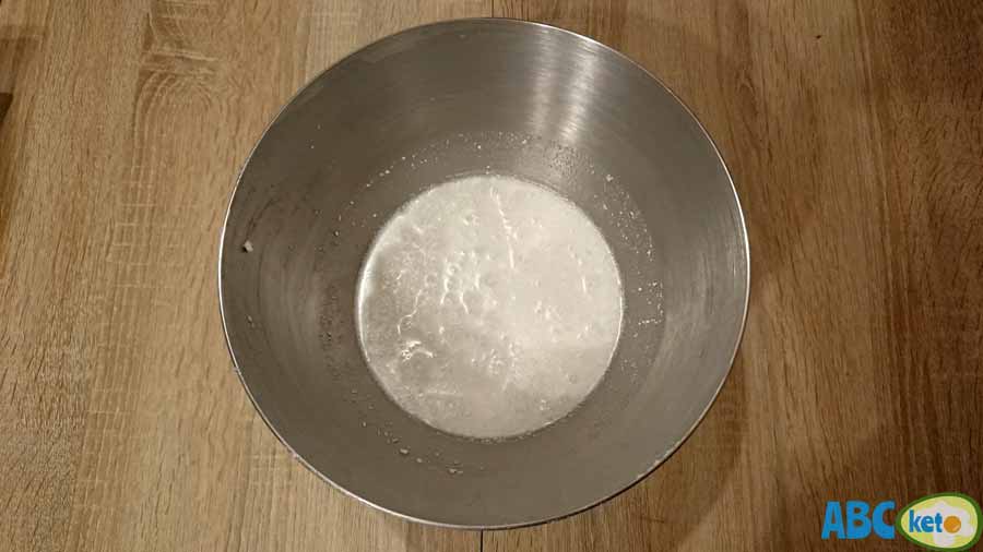 Raffaello fat bombs instructions, pouring coconut milk into a bowl