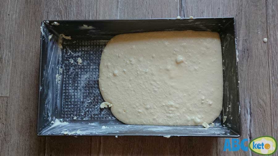 Pouring keto cheesecake onto the baking form